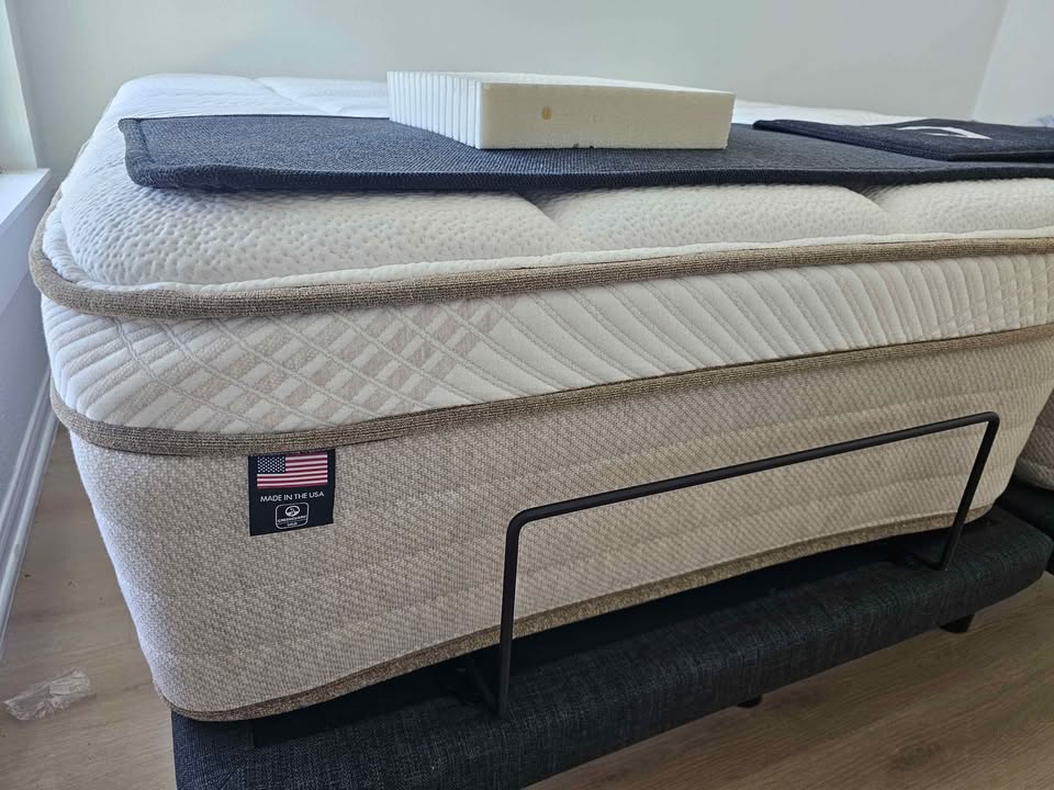 Max Airflow Natural Euro Top mattress on a dark bed frame in the Organic Mattress House showroom.